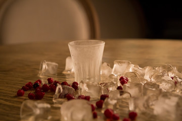 Fototapeta na wymiar Icy alcohol shot with ice and berries