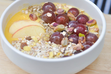 mango yogurt with apple, oat and grape topping