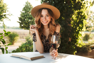 Pretty young woman drinking wine.