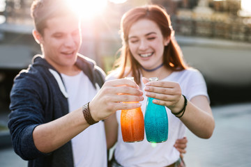 Absolutely delicious. Selective focus of tasty drinks being held by positive young people