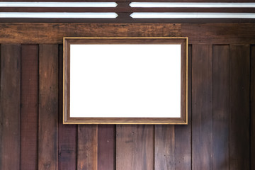 Mockup image of an antique golden picture frame with blank white screen on wooden wall background