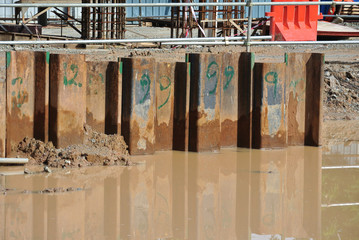 Temporary sheet pile cofferdam retaining wall at the construction site. It is installed to allow...