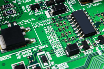 Macro shot of a Circuitboard with resistors microchips and electronic components. Computer hardware technology. Integrated communication processor. Information engineering. Semiconductor. PCB. Closeup