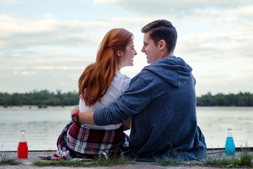 Romantic story. Positive young couple smiling to each other while being in love