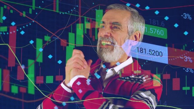 An elderly man looks at stock market and celebrates