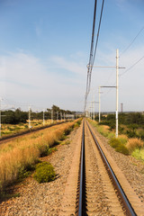 Fototapeta na wymiar Straight Railroad Tracks in Rural Area