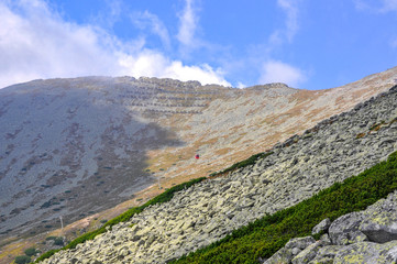 Cable car in mountains with blue sky and clouds
