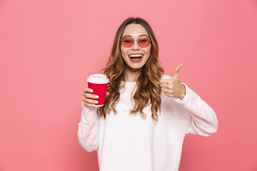 Portrait of a cheerful young woman in sunglasses