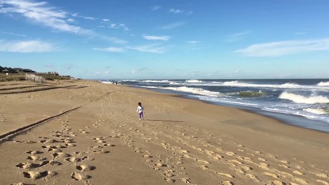 Child running on the beach on the Outer Banks, North Carolina