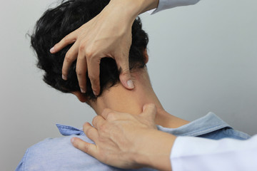 Closeup of Doctor examines or treatment the man with shoulder pain or neck pain on white...