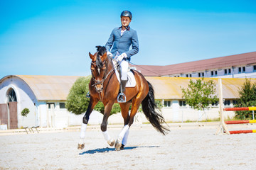 Active man. Professional experienced horse man feeling active while riding his brown racehorse