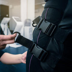 Closeup of young woman preparing athlete for EMS training