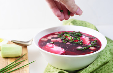 Beetroot soup garnished with egg, cucumber and cream fresh