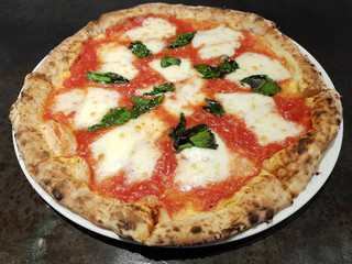 Close-up shot of wood-fired oven margarita pizza