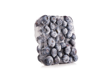 Ice cube with blueberries isolated on white