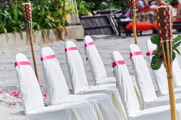 Wedding chairs white cover with red pink organxza decoration settings for beach wedding venue