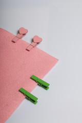 Subjects for needlework. Cloth and wooden clothespins with hearts.