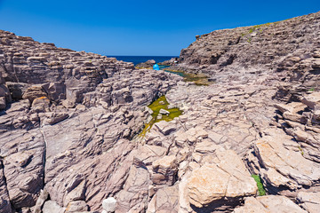 Rock formations on the cliffs of the island of San Pietro in Sardinia, Italy.