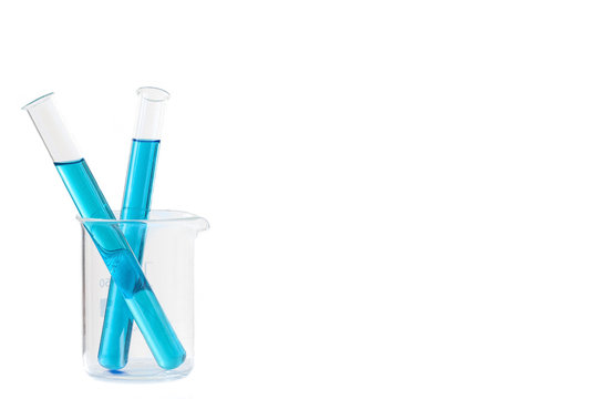 Two Laboratory tubes with blue liquid in measuring beaker with reflection isolated on white