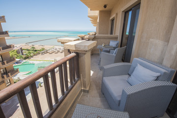 Fototapeta na wymiar Terrace balcony with chairs in tropical luxury apartment