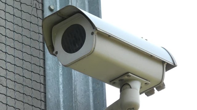 Closeup on a safety camera on a corner of a building wall