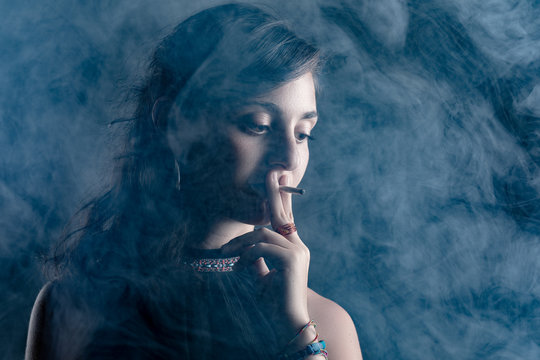 Woman Smoking a Cigarette Surrounded with Smoke
