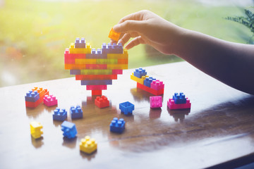 People are playing on rainbow heart Blocks toys.