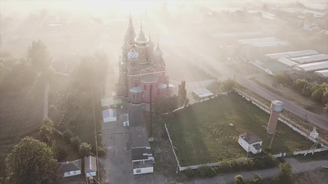 Picturesque 100 year old church in the small village of Russia - in the foggy sunset
