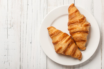 Fresh croissants on a plate - 217176235
