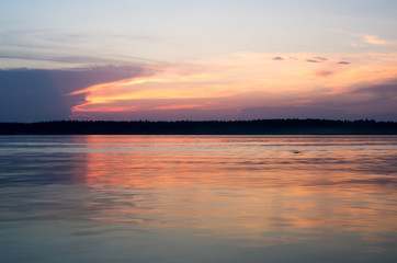 Fototapeta na wymiar Sunset on the lake. Beautiful sunset nature. Evening landscape. Clouds over the lake. The horizon at sunset. Sea, lake at sunset.