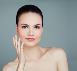 Young woman with healthy skin on blue background. Cosmetology, skincare, spa and wellness concept