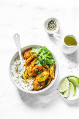 Potatoes and green beans curry sauce with rice and cilantro. Indian vegetarian healthy food on grey background, top view
