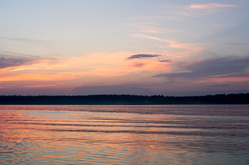 Fototapeta premium Sunset on the lake. Beautiful sunset nature. Evening landscape. Clouds over the lake. The horizon at sunset. Sea, lake at sunset.