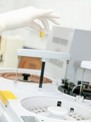 hand in a glove loads medical tests samples into the automatic clinical diagnostic device