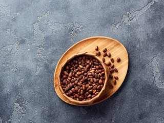 Pine nuts in bowl on gray stone table. Top view with copy space