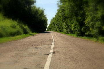 An empty rural asphalt road in the middle zone of Russia.