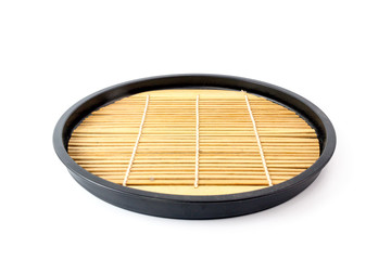 Round wooden tray in japanese style with bamboo inside isolated
