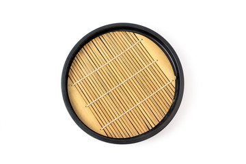 Round wooden tray in japanese style with bamboo inside isolated