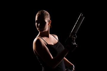 Military woman with a gun over black background