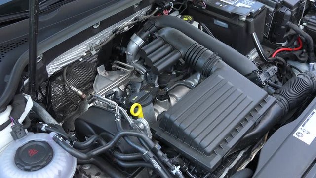 Closeup on a car engine under a hood