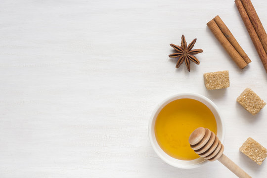 Honey, brown sugar and star anise with cinnamon on light background. Copy space for text.