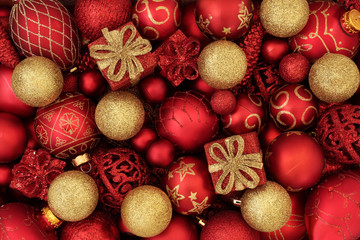 Red and gold christmas bauble decorations forming an abstract festive background. Traditional christmas greeting card for the holiday season.