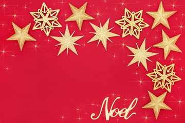 Christmas abstract with glitter star bauble decorations and gold noel sign on red background with copy space. Traditional festive card for the Christmas holiday season.