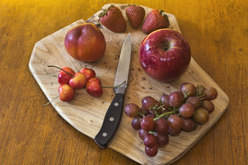 Red Fruit on Cutting Board