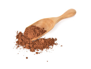 Cocoa powderl in wooden spoon on white background