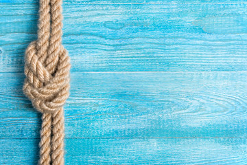 Rope, knot and background wood