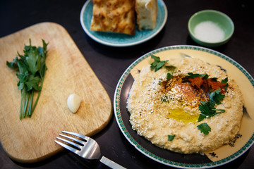 Lentil hummus in bowl and pita bread on wooden table