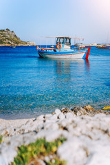 Colorful greek fishing boats at the calm clear water on early summer morning