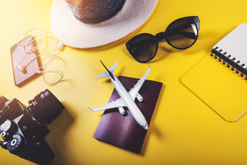 time to travel. traveler accessories on yellow background