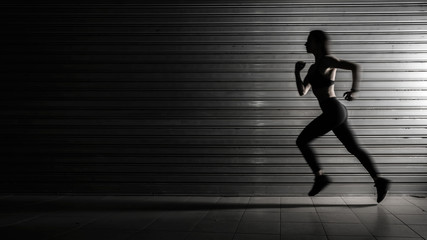 Silhouette of fitness woman running